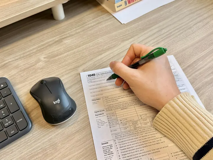 Hands completing a tax planning document